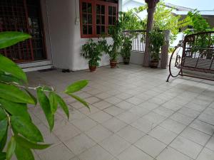 a patio with potted plants on a house at Homestay Bemban Batu Gajah in Batu Gajah