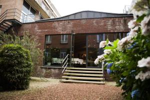 a brick building with a staircase in front of it at Alfa Inn in Blankenberge