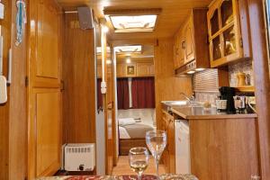a kitchen with two wine glasses on a table at Lemon Garden Camper in Chania Town