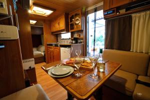 a small table with wine glasses and food on it at Lemon Garden Camper in Chania Town