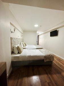 a bedroom with a large bed and a flat screen tv at Antik Ipek Suit in Istanbul