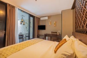 a hotel room with a bed and a balcony at The Sterling Villas in Uluwatu