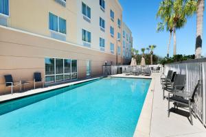 a swimming pool in front of a building at Fairfield Inn & Suites Fort Pierce / Port St Lucie in Fort Pierce
