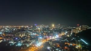 a city lit up at night with lights at Unixx in Pattaya South