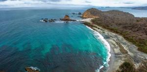 an aerial view of a beach with turquoise water at La Fogata in Machalilla