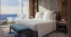a bedroom with a large bed and a large window at Jumeirah Beach Hotel Dubai in Dubai
