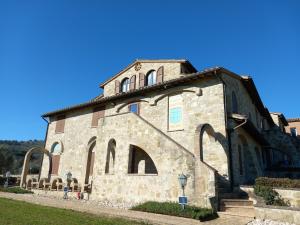 a large stone building with arches on it at Antico Borgo Carceri & Wellness in Bevagna