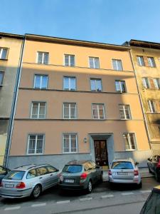 a building with cars parked in front of it at Akt Studio Apartment City Centre in Krakow