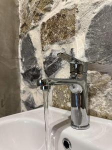 a sink with a water faucet in a bathroom at Rouvas Villas in Apomarmá +79 photos