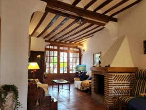 a living room with a couch and a fireplace at La Casa de la Plazuela, Morata de Tajuña in Morata de Tajuña