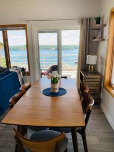 a dining room table with a view of the ocean at The best lake view in Ozark. in Lake Ozark