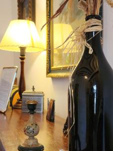 a bottle of wine sitting on a table with a lamp at La Casa de la Plazuela, Morata de Tajuña in Morata de Tajuña