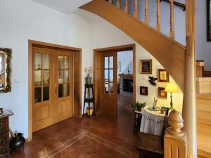 a hallway with a staircase and a table in a house at La Casa de la Plazuela, Morata de Tajuña in Morata de Tajuña +29 photos