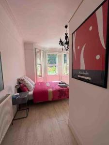 a bedroom with a bed and a flat screen tv at Bournemouth. Private Self Contained space. in Bournemouth
