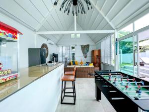 a living room with a ping pong table at One Villa Samaesarn in Ban Samae San