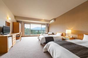 Postel nebo postele na pokoji v ubytování GLOBAL RESORT NUKUI