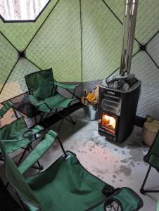 a tent with two chairs and a stove in it at KURA Nagomi Hida Takayama - Camp - Vacation STAY 62749v in Takayama