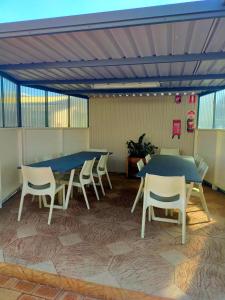 a group of tables and chairs in a room at Bayview Motel in Esperance