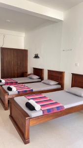 two beds sitting in a room with at Dream Villa with Pool in Habaraduwa