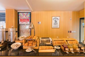 a bakery with bread and pastries on a counter at Galleria 12 Sukhumvit Bangkok by Compass Hospitality in Bangkok