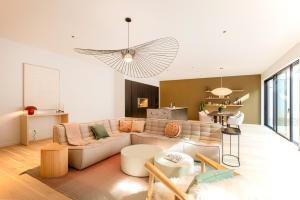 a living room with a couch and a table at Villa Marie climatisation piscine & jardin Dijon centre in Dijon