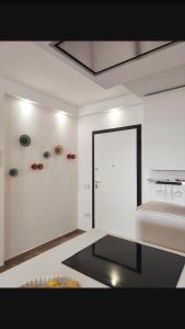 a white kitchen with a door and a counter top at Domu sa luna mia in Villasimius +37 photos