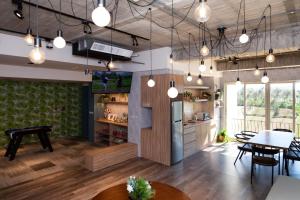 a kitchen and dining room with a table and chairs at Lovestar Lakeside Hotel - Stars Building in Nanwan