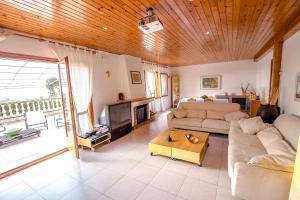 a living room with a couch and a table at Swiss style villa near Barcelona 10min to beach in Sant Cebrià de Vallalta