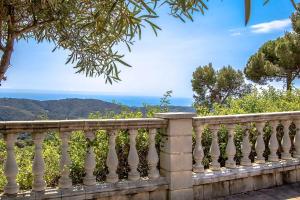 a stone fence with the ocean in the background at Swiss style villa near Barcelona 10min to beach in Sant Cebrià de Vallalta
