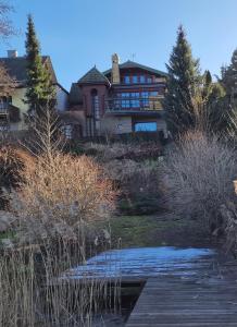 a large house with a pond in front of it at Apartament " La Dolce Vita " in Bryzgiel