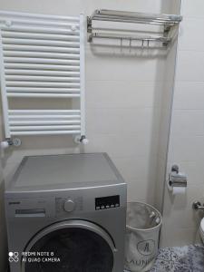 a washing machine in a bathroom with a window at Dream apartment in Batumi