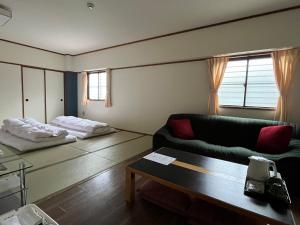 a living room with a couch and a table at Sakuraya in Miyajima +40 photos