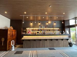 a kitchen with a counter and a bar at Sakuraya in Miyajima