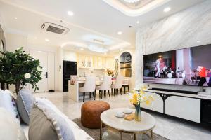 a living room with a large flat screen tv at Midtown The Peak By Dhome in Ho Chi Minh City