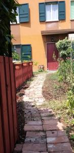 a stone path in front of a house at Serendipity in Castelbelforte +2 photos