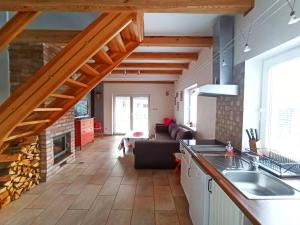 an open kitchen and living room with a fireplace at Kostek in Rowy