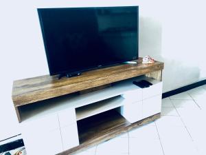 a flat screen tv on top of a tv stand at Nyali Casa Beach Bliss in Mombasa