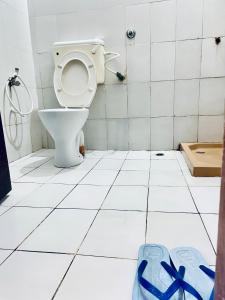 a bathroom with a toilet with blue bows on the floor at Nyali Casa Beach Bliss in Mombasa