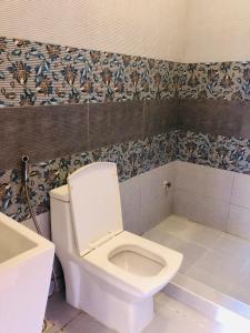 a bathroom with a toilet and a sink at Apartment in Dar es salaam, Palm Village in Dar es Salaam