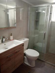 een badkamer met een toilet en een glazen douche bij Triopetra hill view in Triopetra