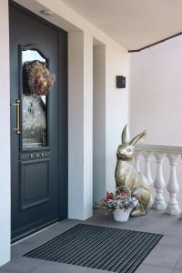 a door with a stuffed rabbit sitting next to it at Eagle's Nest Ljubljana in Ljubljana