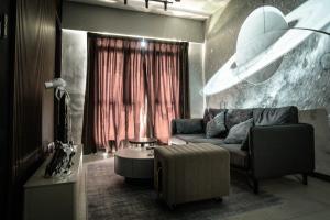 a living room with a couch and a table at K Avenue by CAIRO in Donggongon