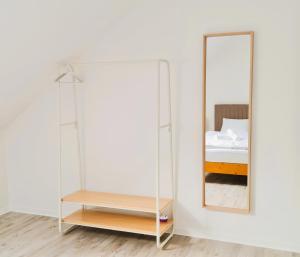 a mirror on a wall next to a bedroom at Apartment Nähe Airbus in Manching