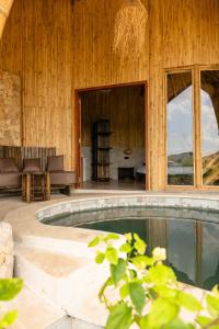 a swimming pool in the middle of a house at Villa con Piscina Vista Mare - Lussuosa - Villa Chiara, Anima Eco Lodge in Selong Belanak