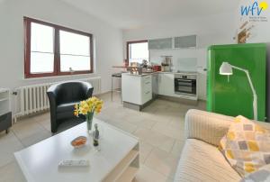 a living room with a couch and a table at Dünenschlösschen Ferienwohnung 45 in Wangerooge