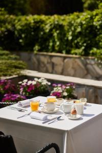 a white table with bowls and cups and eggs on it at Iriarte Jauregia in Bidania-Goiatz