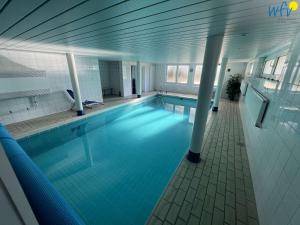 a large swimming pool in a building at Dünenschlösschen Ferienwohnung 45 in Wangerooge