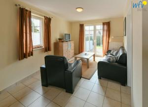 a living room with two chairs and a couch at Villa Cila Ferienwohnung 5 in Wangerooge