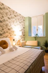a bedroom with a large bed and a couch at The Convo Lake Como in Como