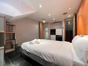 a bedroom with a large bed with towels on it at Multi-Award Winning 7 Storey Home - Near Shoreditch in London